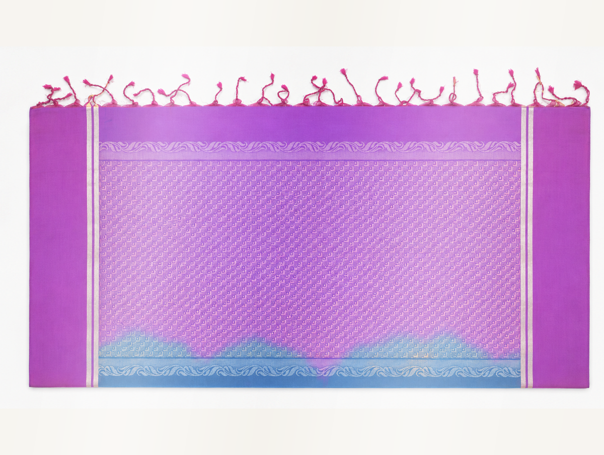 Close product view of the orchid-magenta purple geometric woven pallu with silver-toned leafy-vine bands, paired pale metallic side lines and short tassels.