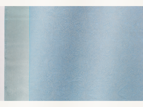 Close view of the ice blue saree body with dense tonal floral paisley jacquard and pale silver border
