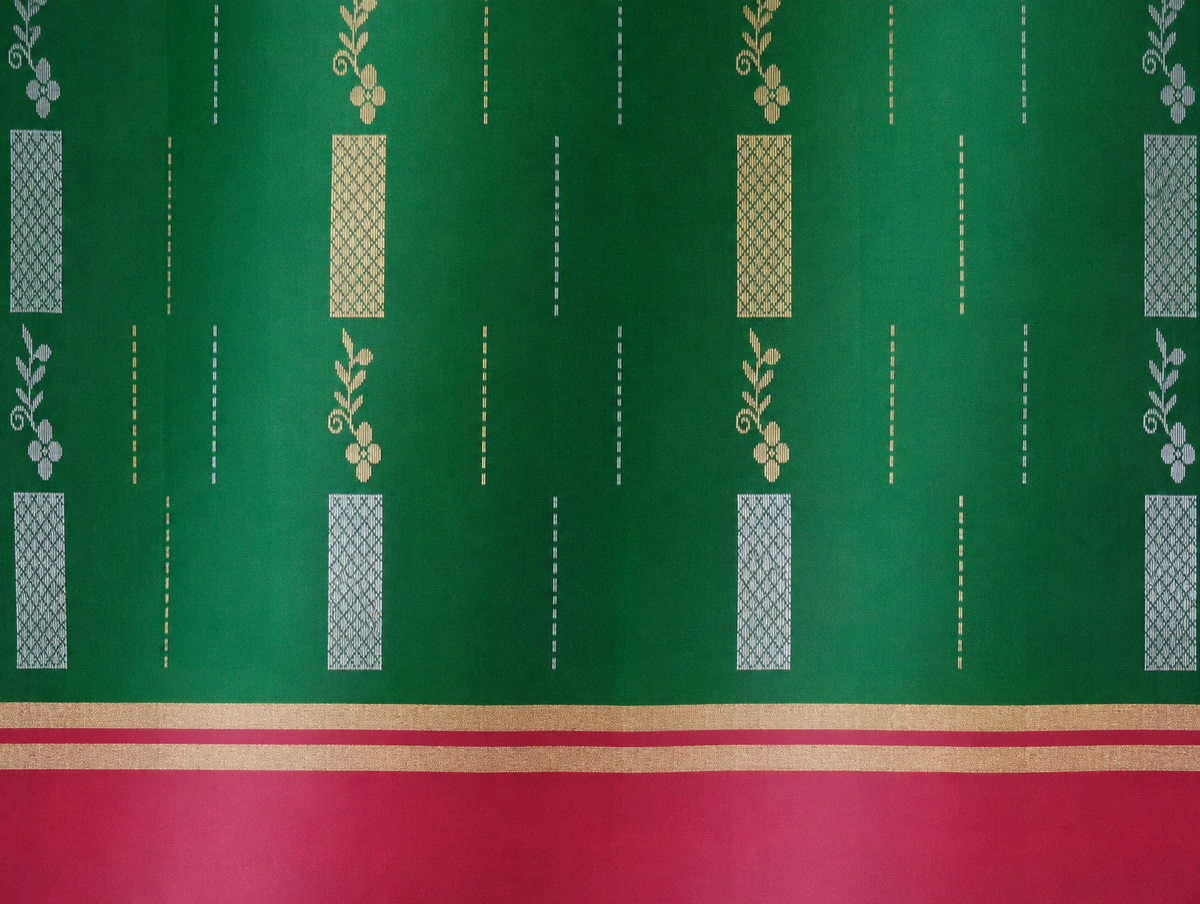 Close detail of the Vanya emerald-green body with alternating gold- and silver-tone woven motifs and a dusty-rose border.